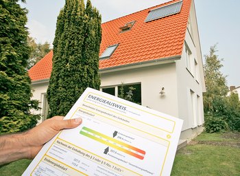 Eine Person hält einen Energieausweis in der Hand